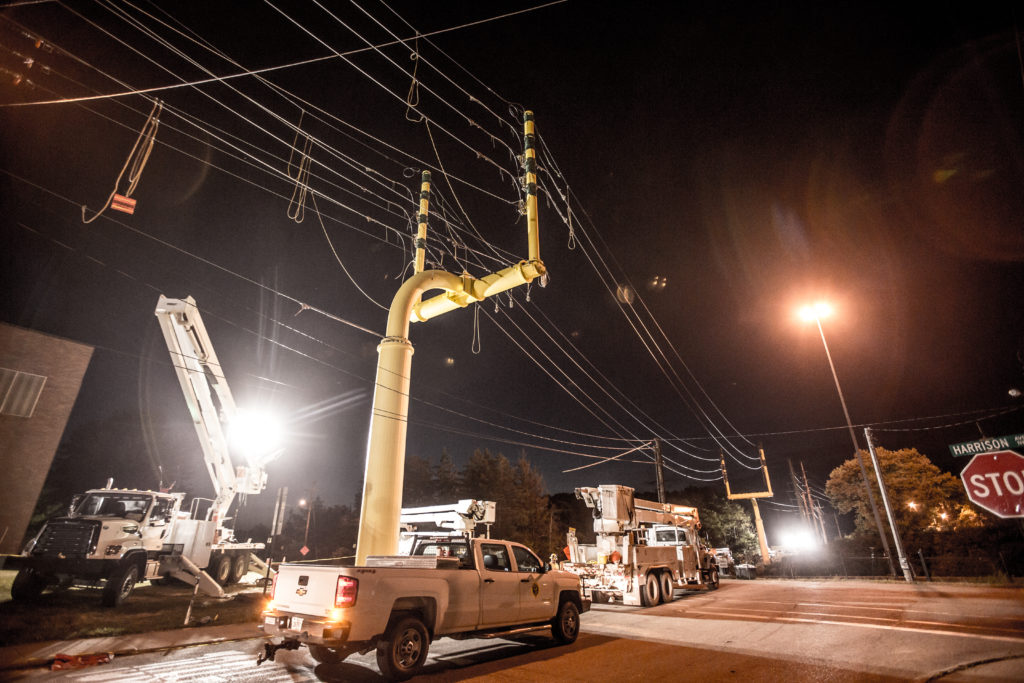 The overhead industrial electrical tower in the shape of a goal post sitting above two NRE work trucks in Canton, Ohio.