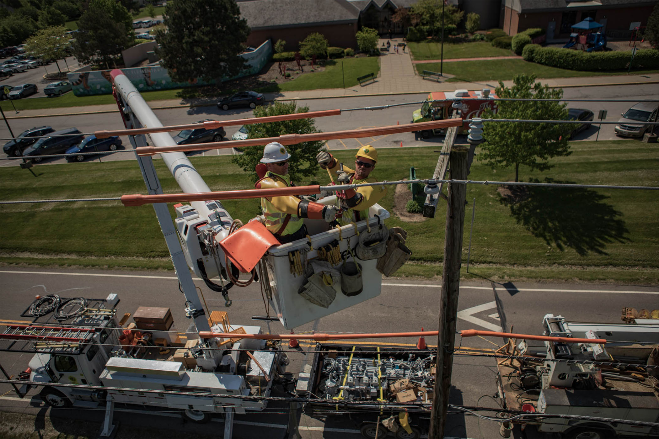 New River Electrical employees doing an overhead job in a crane bucket.