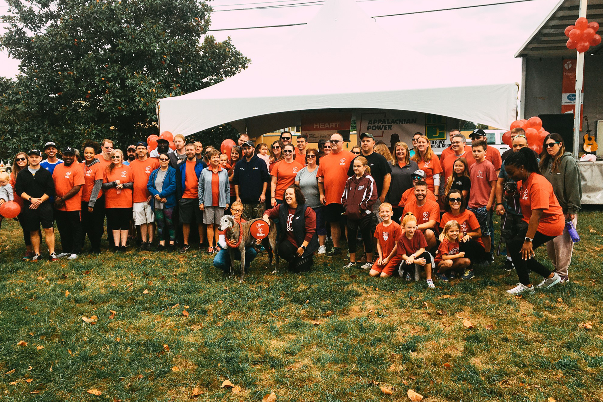 New River Electrial employees in red shirts posing at the American Heart Association Heart Walk.