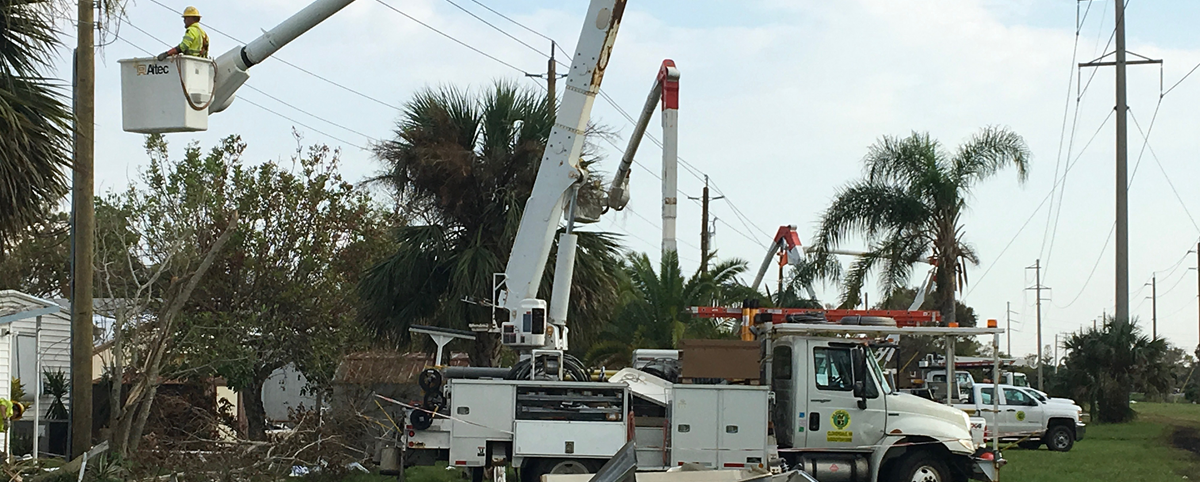 A New River bucket truck restoring power to overhead lines from bucket trucks in Florida.