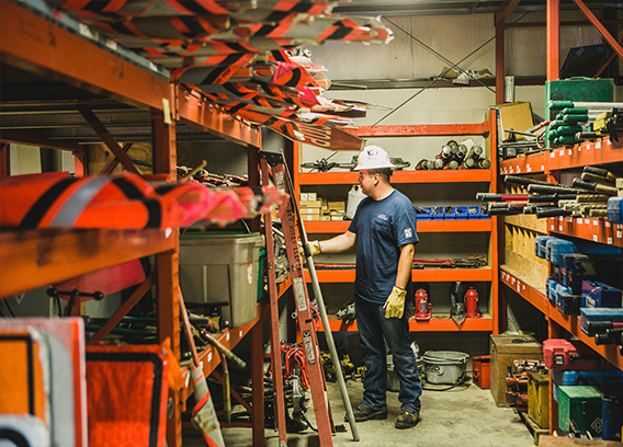 A New River employee inspecting safety equipment at our storage center.