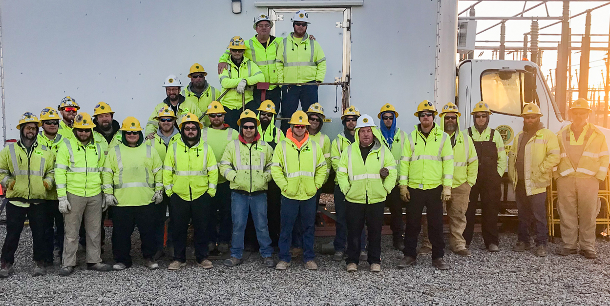 A group of New River employees at the Bixby substation project standing in a group.