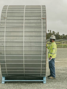 Jason Hurley standing next to a large piece of electrical equipment.