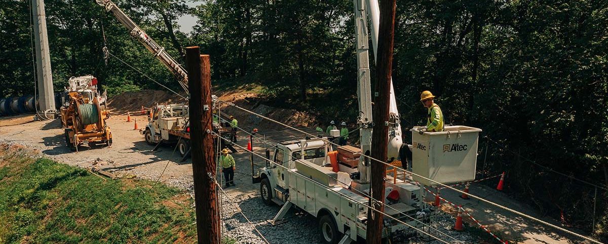 New River Electrical employees and two Altec bucket trucks working on electrical lines in Lynchburg, Va.