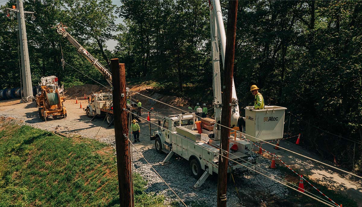 New River Electrical employees and two Altec bucket trucks working on electrical lines in Lynchburg, Va.