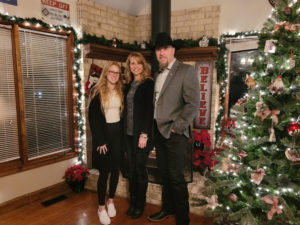 Mark and his family around Christmas tree and lights