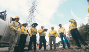 A group of NRE workers having a discussion at a jobsite