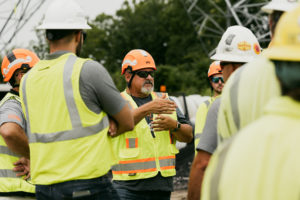 NRE workers having a discussion at a jobsite