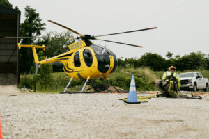 An NRE worker working near a stationary helicopter