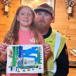 Dad and daughter showing off coloring page