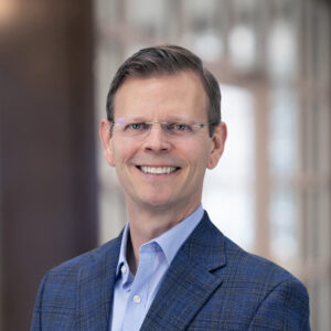 Chris Berk in a professional business setting for his appointment as Vice President of Information Technology at New River Electrical.