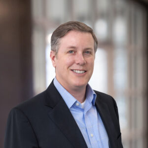 Jeff Barlow in a professional business setting for his appointment as Vice President and General Counsel at New River Electrical.